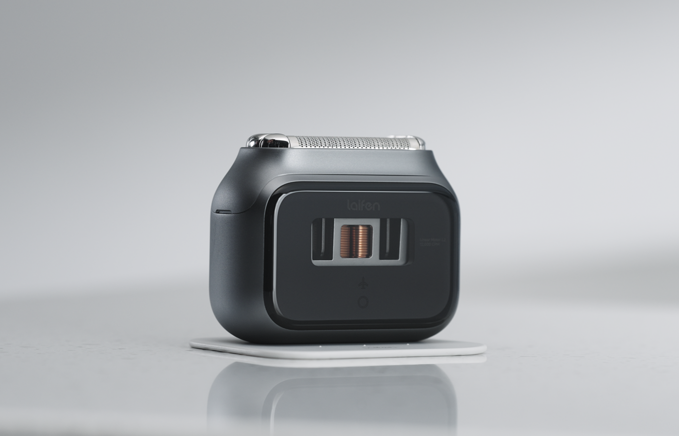 Black electronic shaver on a gray background