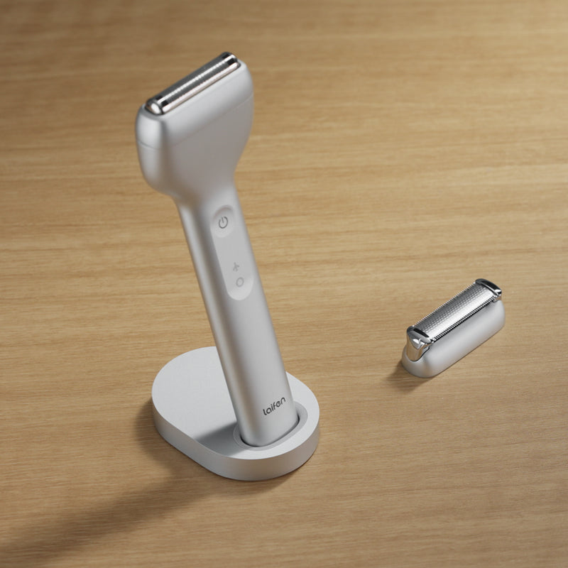 White electric razor with stand on a wooden surface
